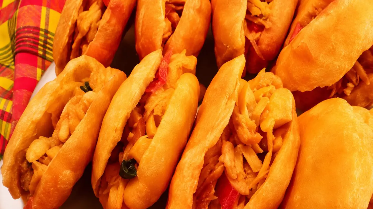 Golden Jamaican johnny cakes split and stuffed with salt fish